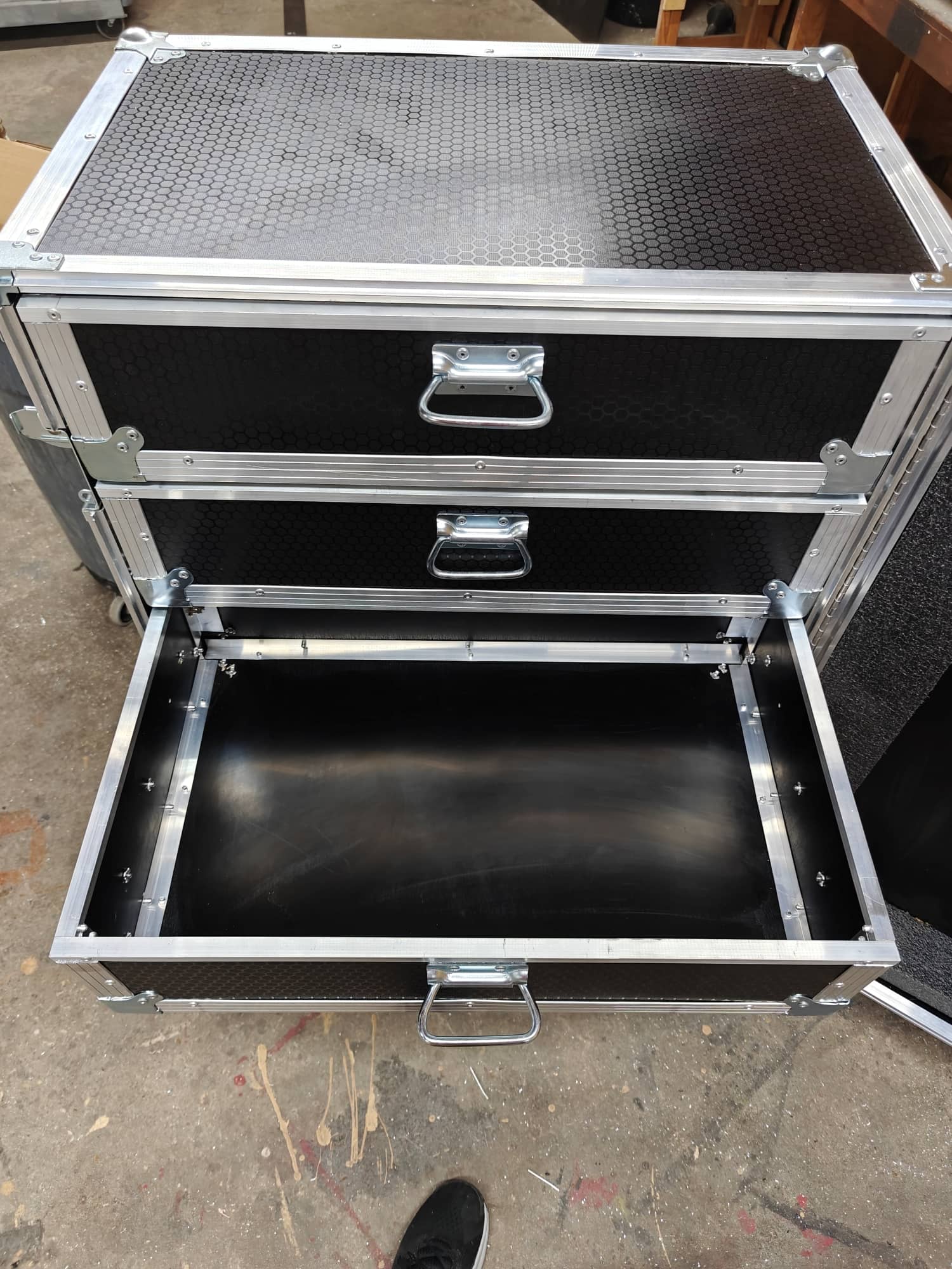 Open flight road case trays showing organized concert touring equipment